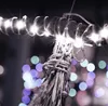 A close-up of a string of lights wrapped around a pole, with bokeh lights in the background. Náhled obrázku produktu