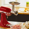 A red KitchenAid stand mixer with a meat grinder attachment is shown with a bowl of ground meat in front of it. Náhled obrázku produktu