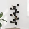 A black corner shelf unit with decorative items on a white wall. Náhled obrázku produktu