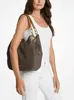 A woman is modeling a Michael Kors handbag. Produktbild-Vorschau