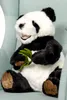 A plush panda bear sitting in a chair. Voir les images du produit