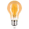 A close-up studio shot of an amber-colored LED light bulb with a silver screw base, isolated on a white background. Náhled obrázku produktu