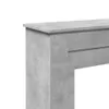 A close-up, partial view of a fireplace surround made of concrete-look material. Podgląd zdjęcia produktu