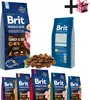 A collage of Brit Premium dog food bags and a pile of dog food kibble, with a gift box and plus sign overlay. Náhled obrázku produktu