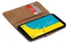 A brown book-style case for a Samsung Galaxy J6 2018 phone, with two credit cards inserted into a slot. Produktbild-Vorschau