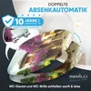 A toilet seat with a decorative print of a building covered in purple flowers, shown in a slightly angled view with a blue arrow indicating movement. Anteprima dell’immagine prodotto