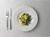 A place setting with a plate of food and cutlery. Produktbild-Vorschau