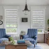 A living room scene with two chairs, a coffee table, and windows with blinds. Produktbild-Vorschau