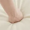 A close-up shot of a hand pressing into a soft, cream-colored surface, likely demonstrating the material's cushioning or texture. Produktbild-Vorschau