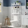 A bathroom with a toilet and an over-the-toilet storage shelf. Náhled obrázku produktu