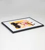 A framed picture of a woman with colorful nails is displayed on a white surface. Produktbild-Vorschau