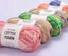Several balls of yarn are arranged diagonally on a light gray surface. Produktbild-Vorschau