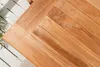 A close-up view of a wooden table surface with planks arranged in a herringbone pattern. Produktbild-Vorschau