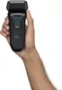 A hand holding a black electric shaver. Anteprima dell’immagine prodotto