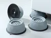 Four anti-vibration pads for a washing machine are shown on a light gray surface. One pad is in the background, and three are in the foreground. One of the foreground pads is partially obscured by another. Voir les images du produit