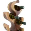 A close-up shot of a wooden wine rack holding several bottles of white wine. Voir les images du produit