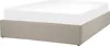 A beige upholstered bed frame with a white fitted sheet. Náhľad obrázku produktu