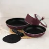 A set of cookware items arranged on a textured surface. Náhľad obrázku produktu