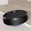 A black robot vacuum cleaner is shown on a floor with a slight incline. Produktbild-Vorschau