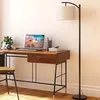 A desk with a laptop, headphones, and a plant, next to a floor lamp. Produktbild-Vorschau