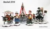 A collection of miniature Christmas-themed figurines including a punch cart, a fountain, a Christmas tree, and a snowman. Produktbild-Vorschau