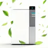 A white air purifier with a grey control panel surrounded by floating green leaves. Anteprima dell’immagine prodotto