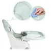 A close-up side view of a green and white baby high chair, with inset circles highlighting the material texture and a hand cleaning the chair. Produktbild-Vorschau