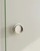 A close-up of a silver recessed door handle on a light gray surface. Produktbild-Vorschau