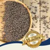 A wooden bowl filled with lentils on a wooden surface, with a marketing badge overlay. Produktbild-Vorschau