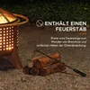 A fire pit with logs and a fire poker in a garden setting. Produktbild-Vorschau