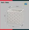 A white ceramic pot with a diamond pattern, shown with dimensions indicated by measurement lines and text. Produktbild-Vorschau