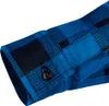 Close-up of a blue and black plaid flannel shirt cuff and button. Podgląd zdjęcia produktu
