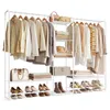 A white metal garment rack filled with clothing, bags, shoes, and folded linens. Produktbild-Vorschau