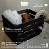 A black wooden crate filled with toys and decorative items. Produktbild-Vorschau