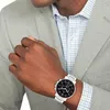 A man wearing a suit and a watch. Produktbild-Vorschau