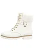 A white women's boot with fur trim and gold accents is shown against a white background. Produktbild-Vorschau
