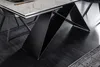 A close-up view of a modern dining table's base and edge, showcasing its design and materials. Produktbild-Vorschau