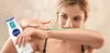 A woman is applying lotion to her arm from a Nivea bottle. Voir les images du produit
