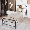 A woman is reading a book on a bed in a bedroom. Náhled obrázku produktu