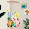 A wall-mounted shelf filled with stuffed animals in a room. Produktbild-Vorschau