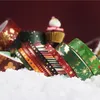 Christmas-themed washi tapes arranged in snow with a cupcake in the background. Produktbild-Vorschau