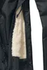 A close-up view of the inside lining and zipper of a black jacket. Produktbild-Vorschau