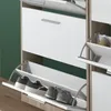 A close-up view of a white shoe cabinet with multiple compartments, some of which are open to reveal shoes inside. Produktbild-Vorschau