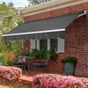 Awnings and outdoor furniture on a brick house patio with flowers. Produktbild-Vorschau