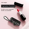 A black mini power bank and a red lipstick are placed on a light pink background. Produktbild-Vorschau