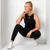 A woman is posing in a squatting position inside a white room. Produktbild-Vorschau