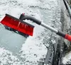 A snow brush is being used to clear snow from a car windshield. Anteprima dell’immagine prodotto
