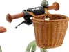 A close-up view of the handlebars and front basket of a child's bicycle. Náhled obrázku produktu