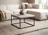 A modern living room scene featuring a sectional sofa, a coffee table, and a rug. Anteprima dell’immagine prodotto