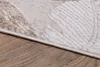 A close-up view of a rug on a wooden floor. Produktbild-Vorschau